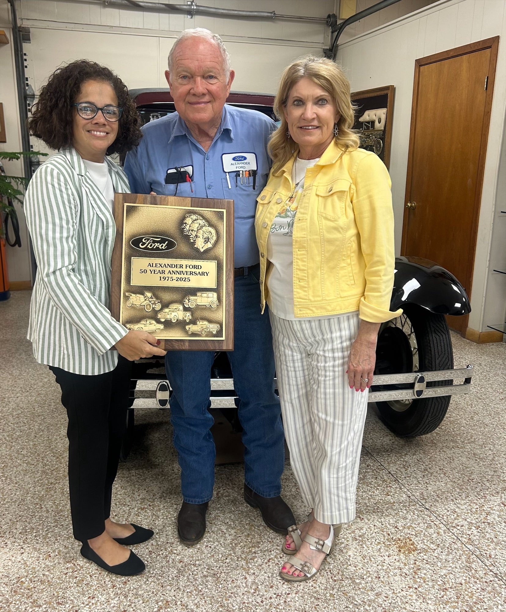 Crucita Santiago, Regional Manager with Ford, presents Bob & Yvonne